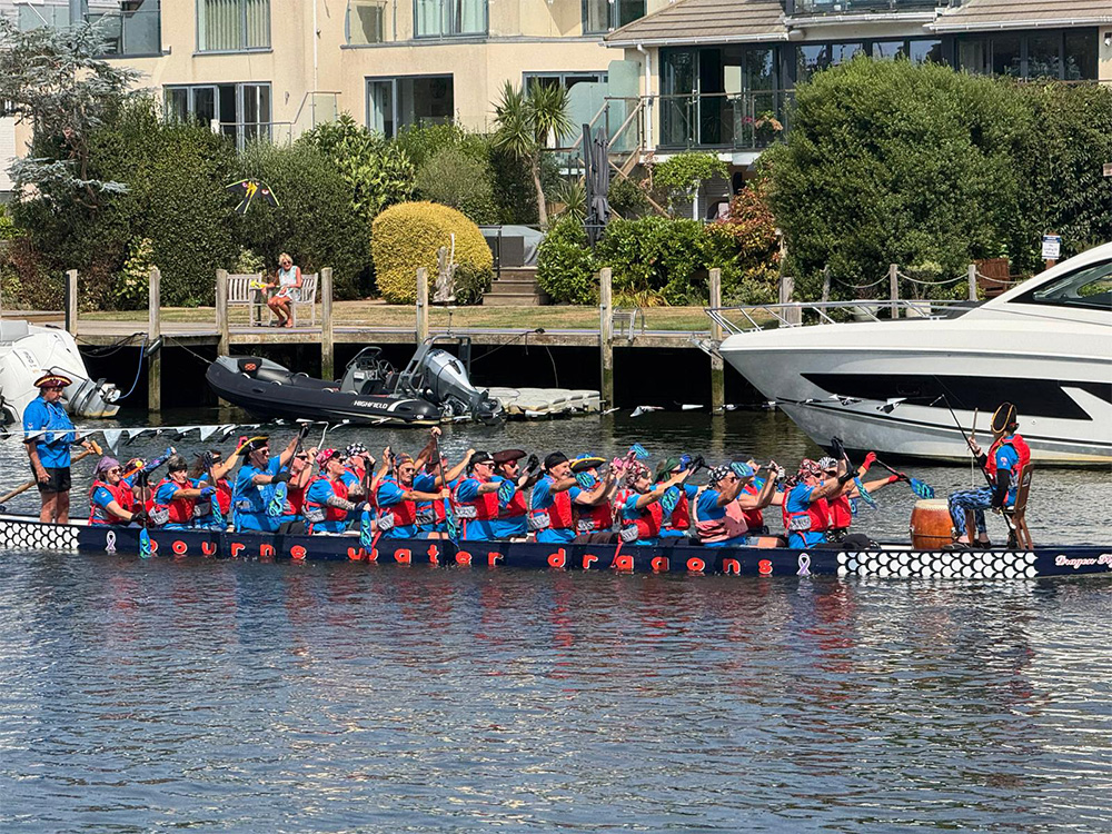 The Bourne Water Dragons attend the vibrant river parade in Christchurch featuring dragon boats, pirates, and sea shanties—raising funds for cancer survivor charities and delighting thousands.