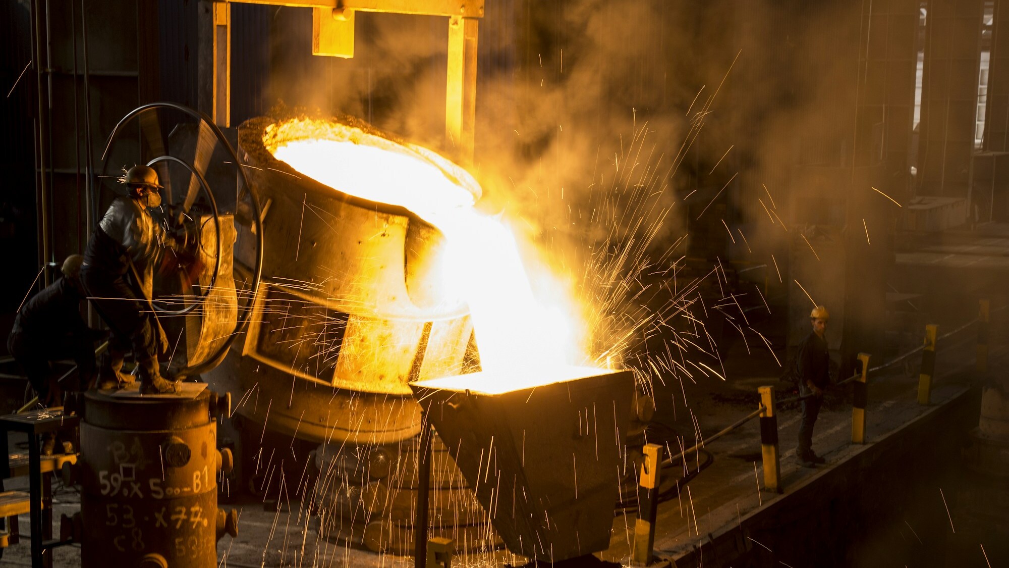 Molten metal poured during fire assay fusion, the high temperature step that collects precious metals into a lead button