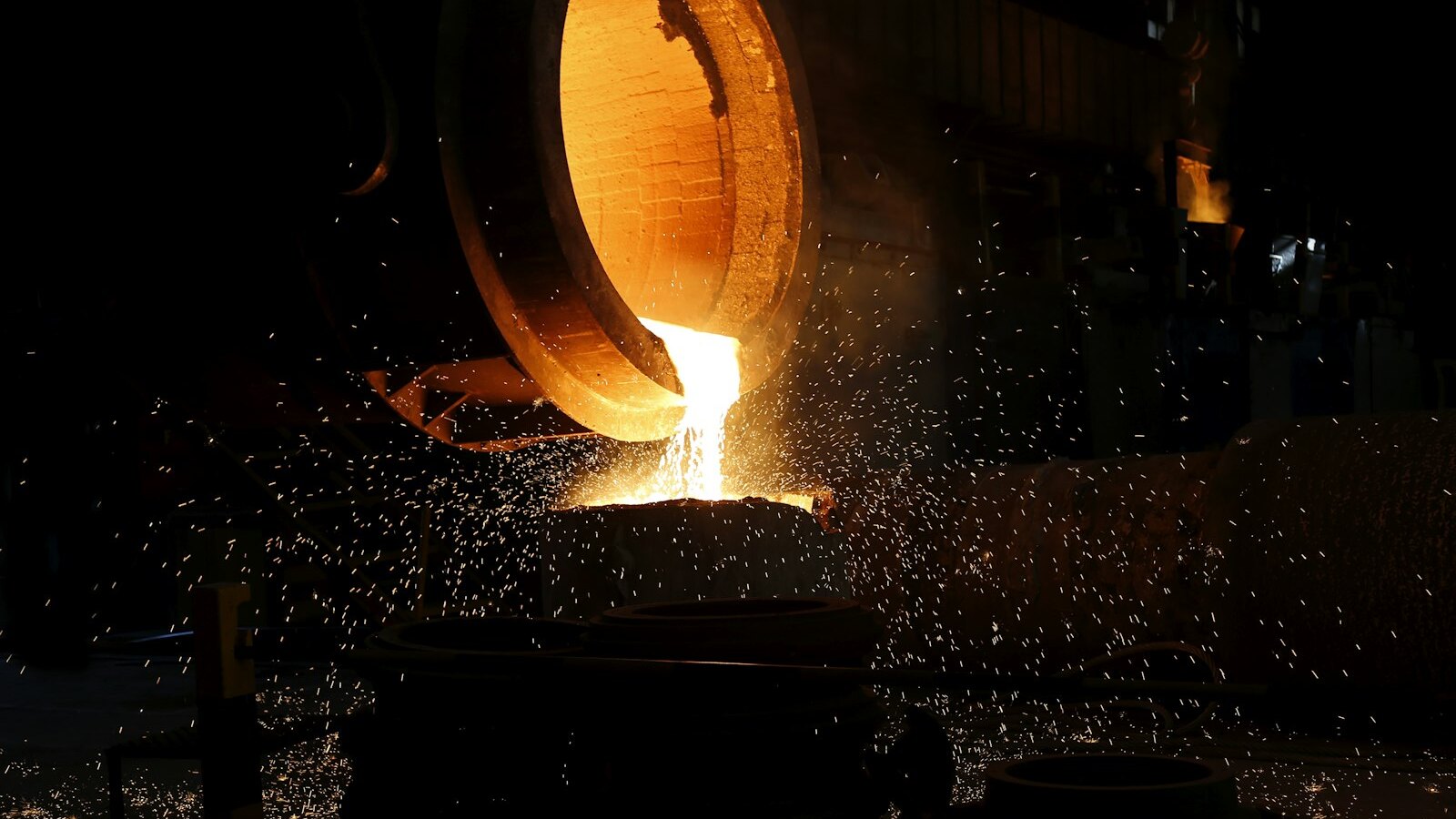 Molten metal being poured during melt sampling for precious metal recovery from spent catalysts