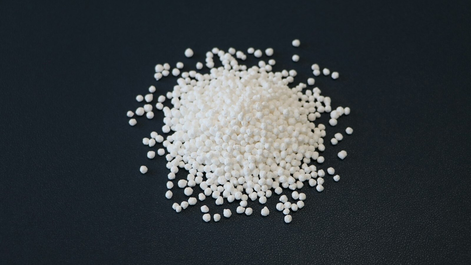 White ceramic catalyst support pellets similar to spent catalyst material processed for precious metal recovery