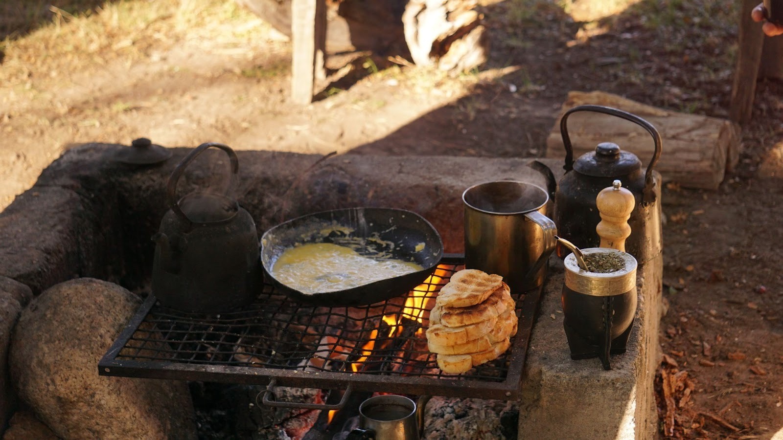 Breakfast being cooked over the fire at sunrise