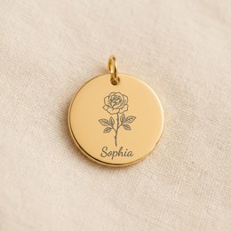 Coin engraved with a birth flower and a name