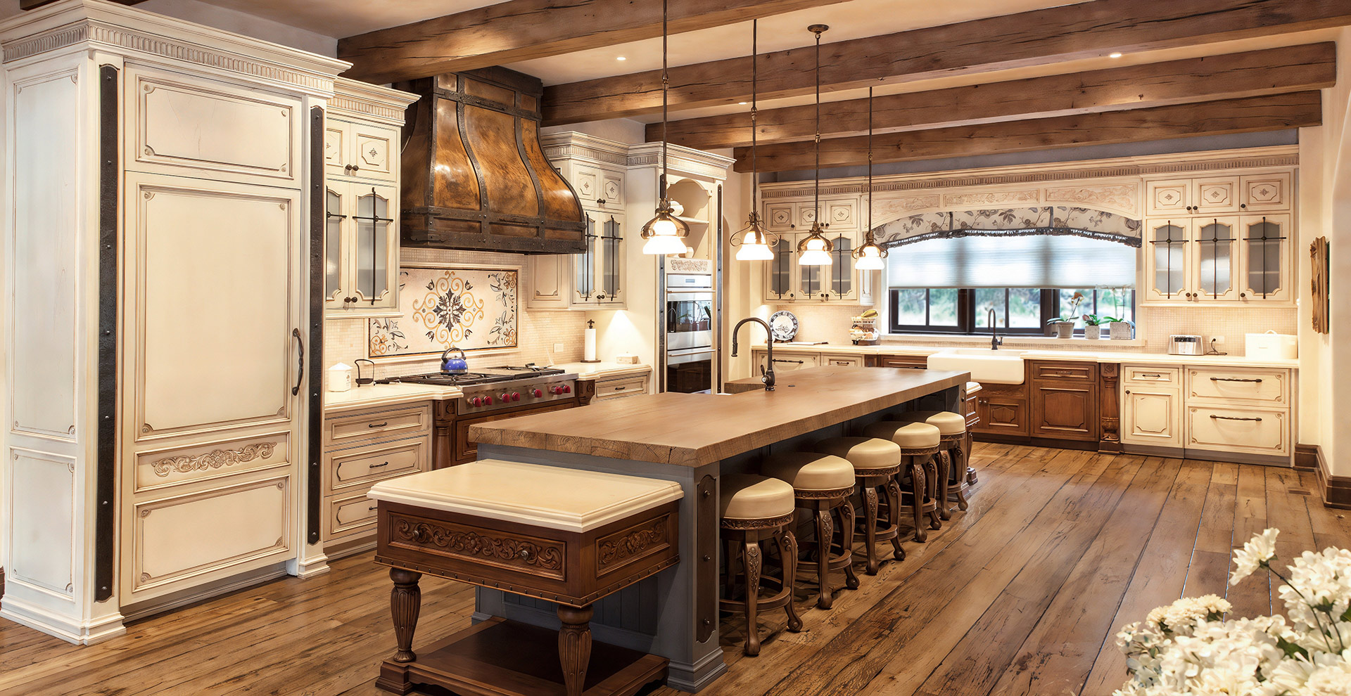 Custom french country kitchen with metal hood