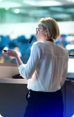 Person using a smartphone with a blurred cityscape in the background.
