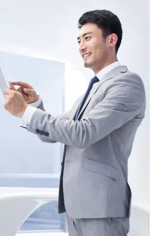 Smiling female scientist or doctor in a lab coat using a digital tablet in a research laboratory