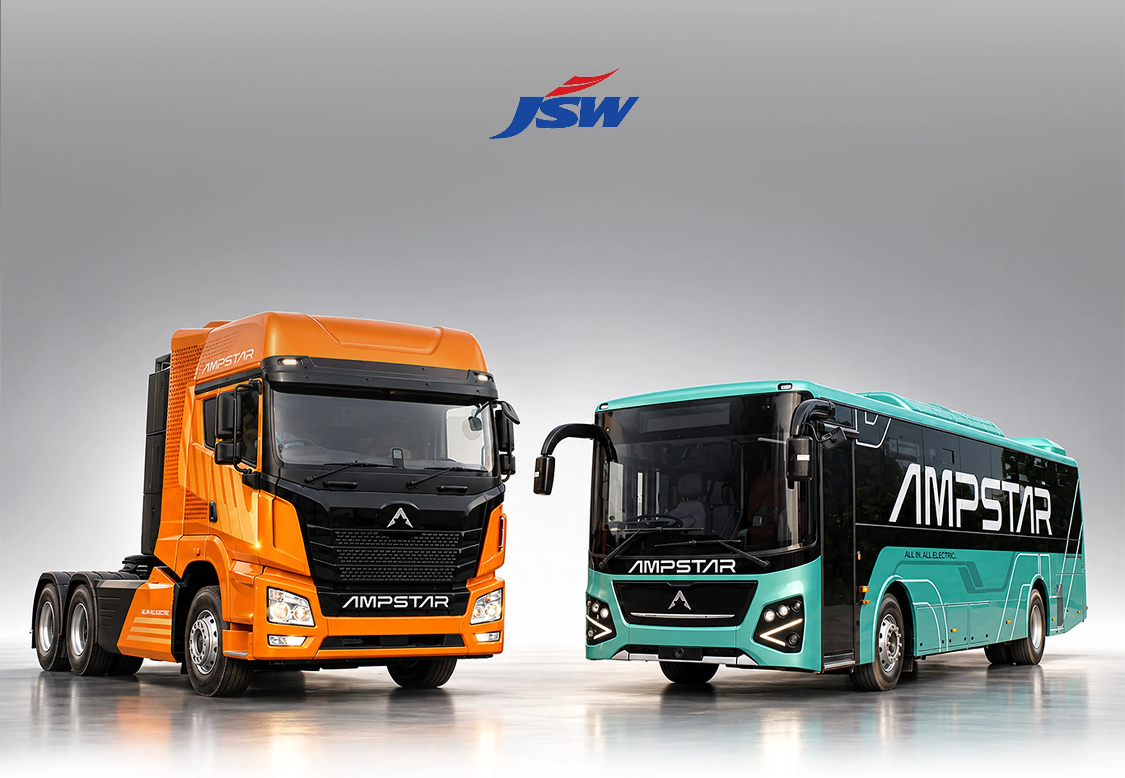 JSW Ampstar — Electrifying a vision. Orange electric truck and teal bus with Ampstar branding.