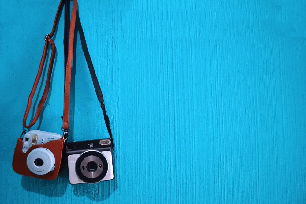 Two cameras hanging influence society