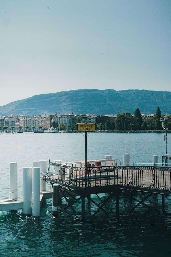 A dock with a sign on it in the middle of a body of water