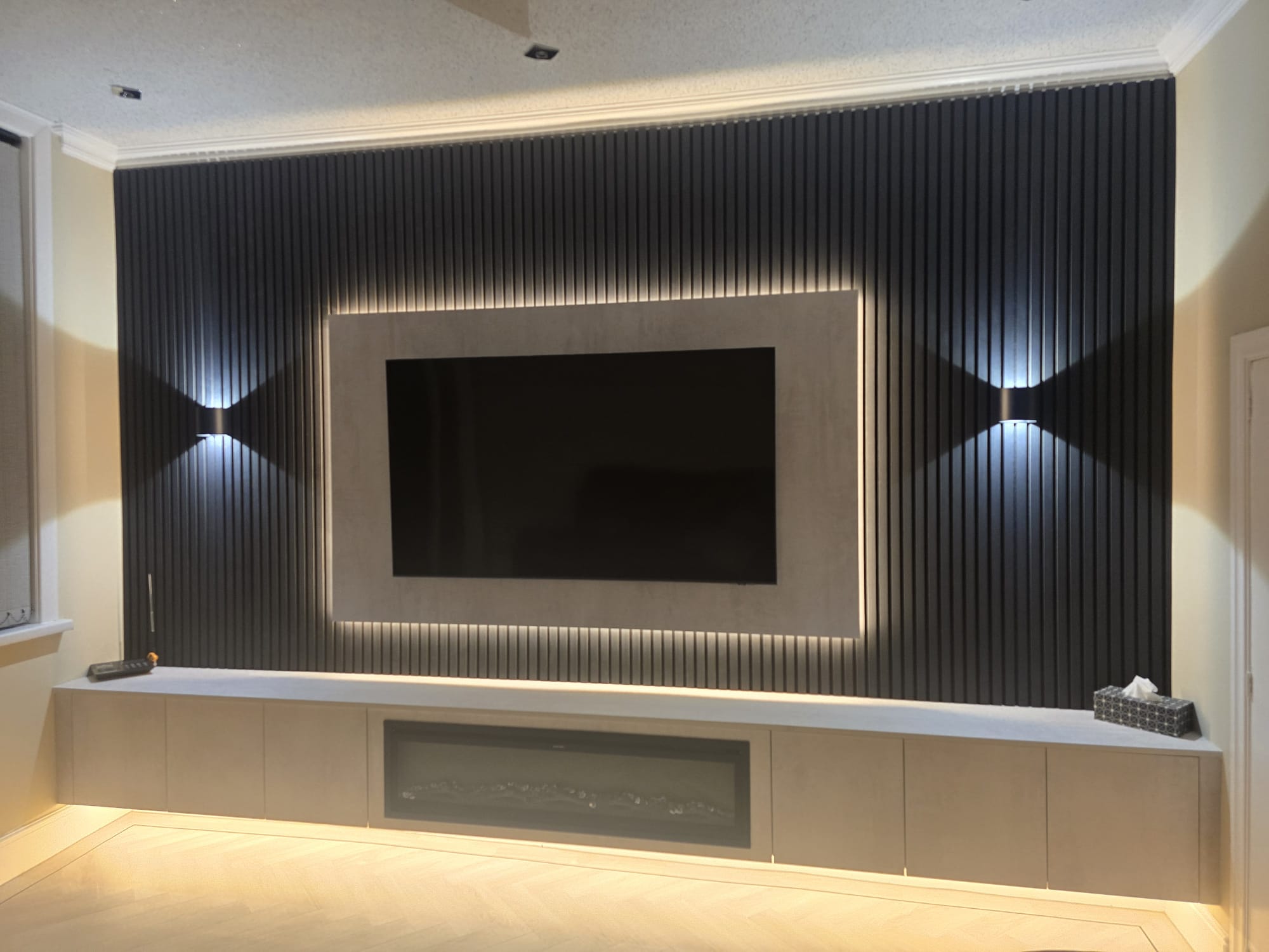 Bespoke media wall supplied and fitted in matte concrete range