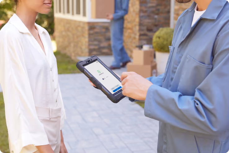 Small business owner ringing up a sale outdoors