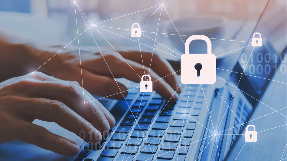 A person is typing on a laptop with a padlock on it