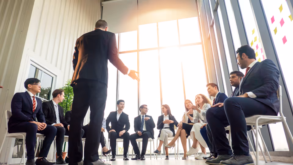A group of business people sitting in a meeting room