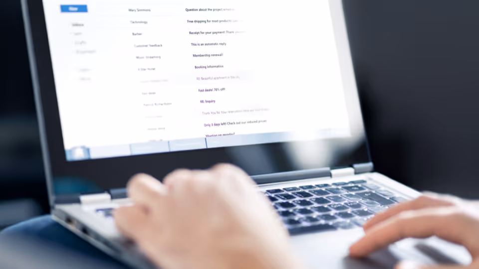 Alt text: A person is typing on a laptop computer screen
