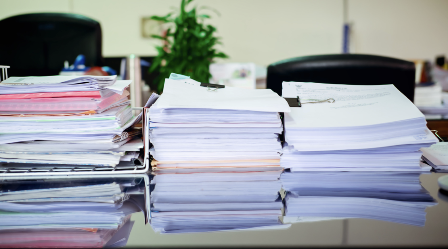 Stacks of papers on a desk in an office