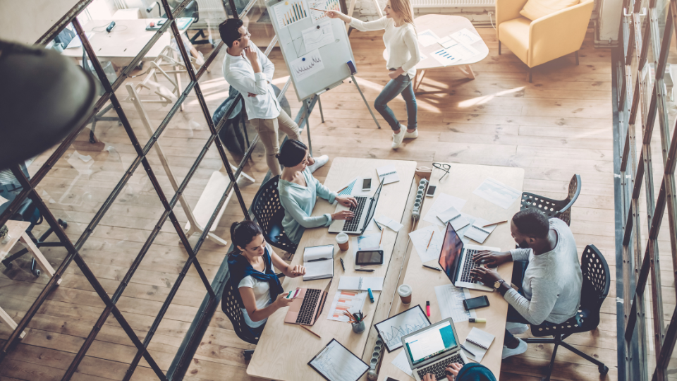 An overhead view of people working in an office