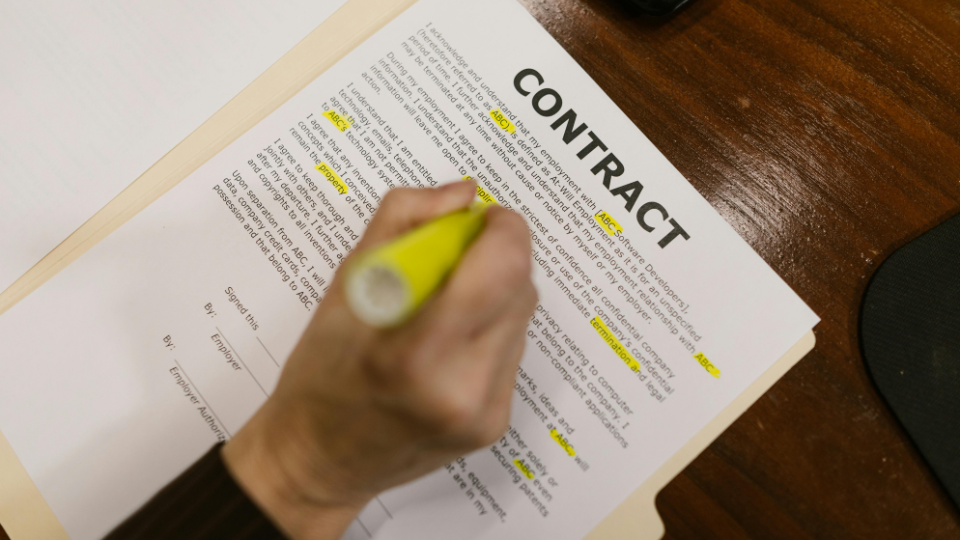 Alt text: A person conducting an in-depth review of a contract