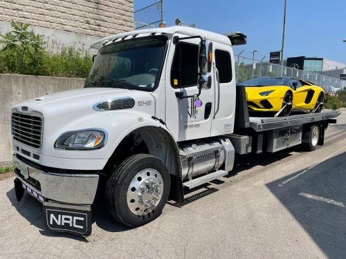 bilal towing flat bed transporting a luxury car