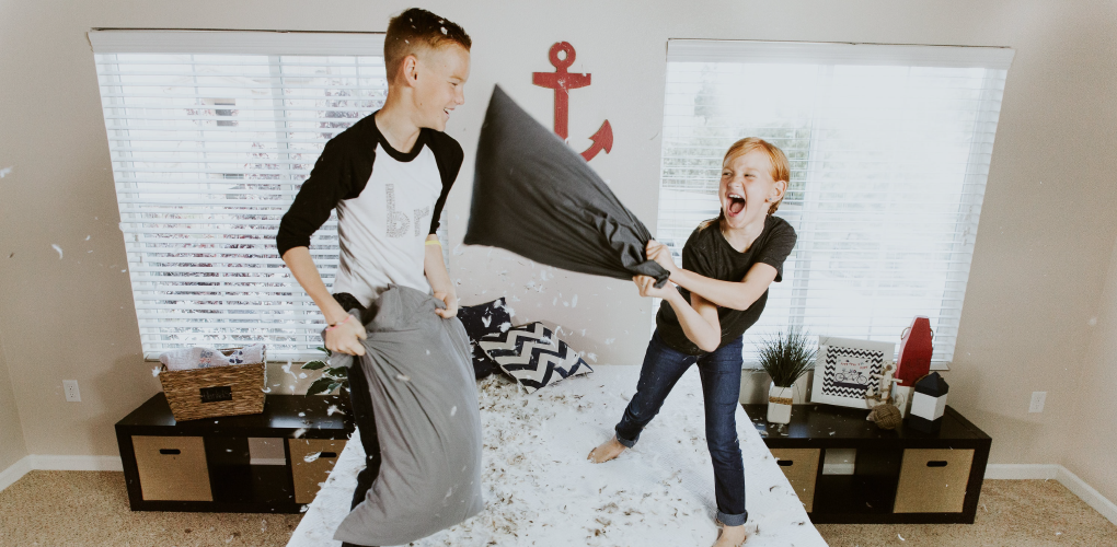 Two kids during a pillow fight