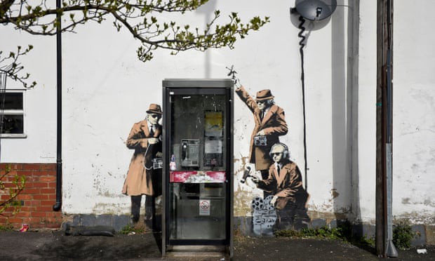 A mural surrounding a phone booth