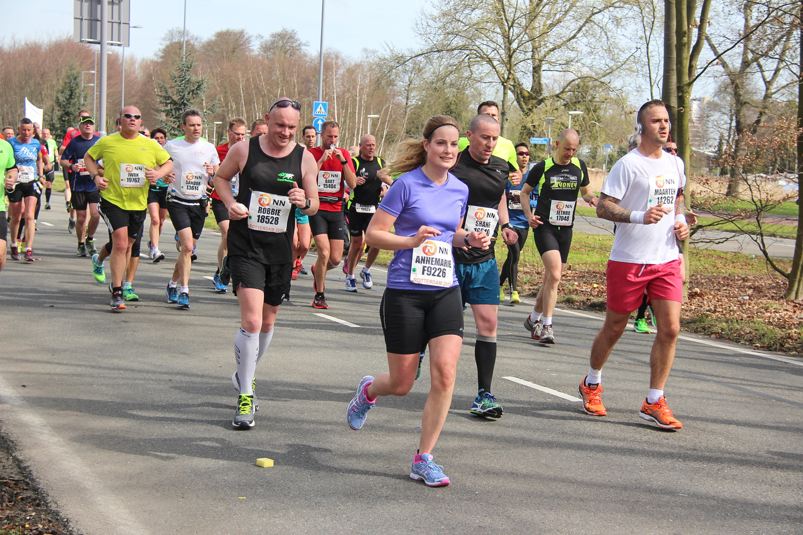 Large group of marathon runners in a park, representing offline-first community activations that create real-world momentum.