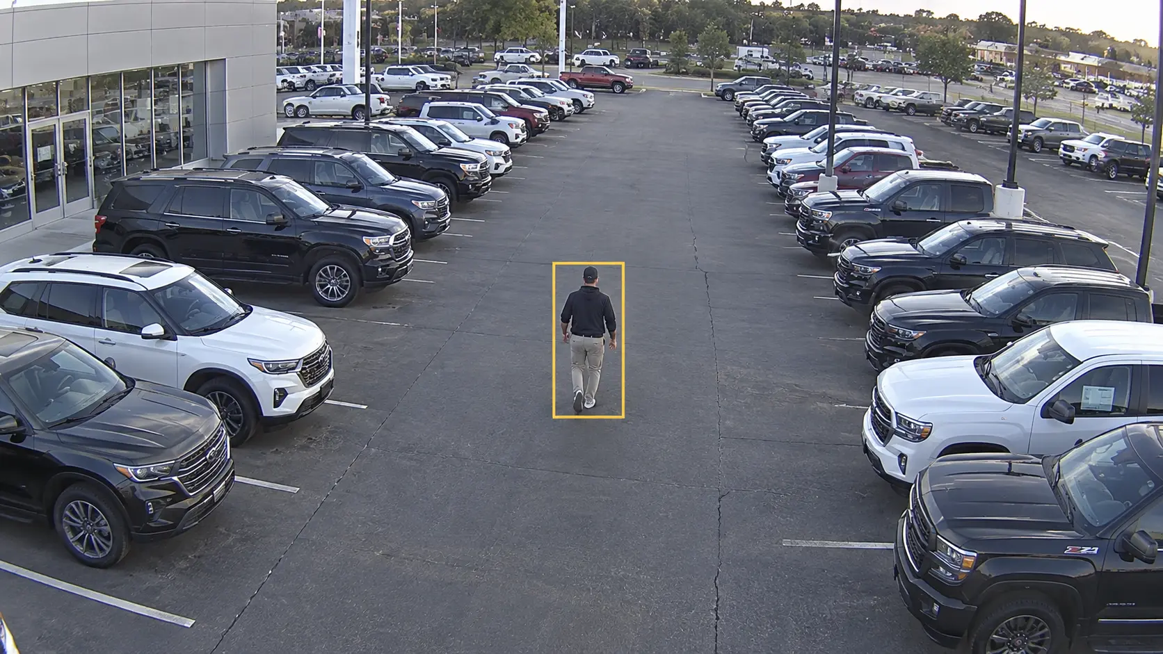AI detection flagging a person walking through a dealership vehicle lot