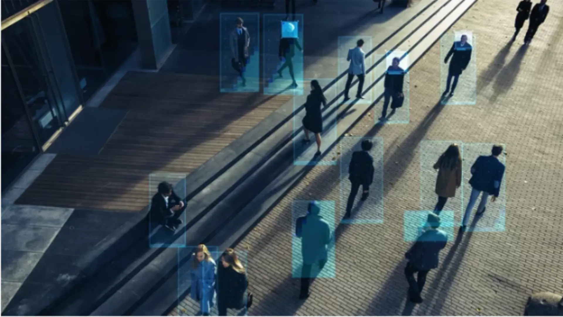 AI-powered video surveillance identifying and tracking people in a commercial outdoor environment.