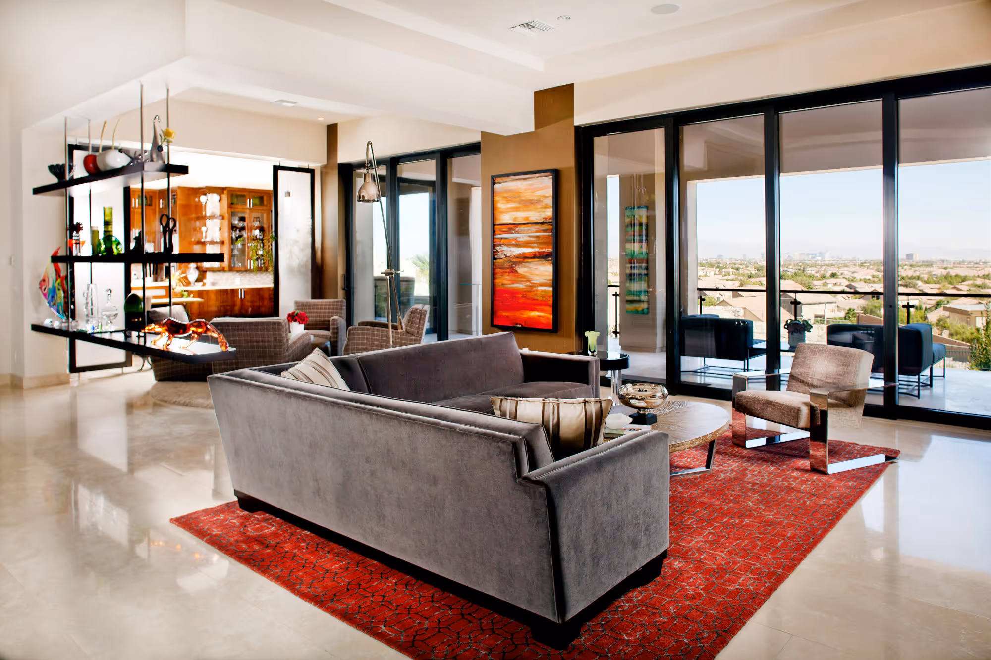 Family room with modern furnishings, large sliders, orange silk area rug, gray velvet sectional.