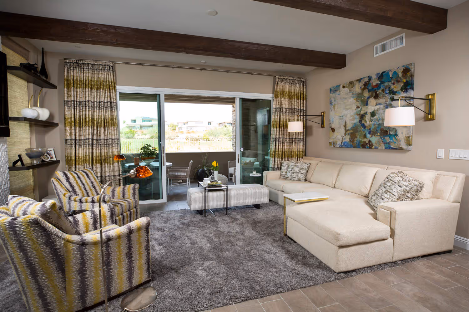 Family room with two yellow and black chairs and cream sectional.