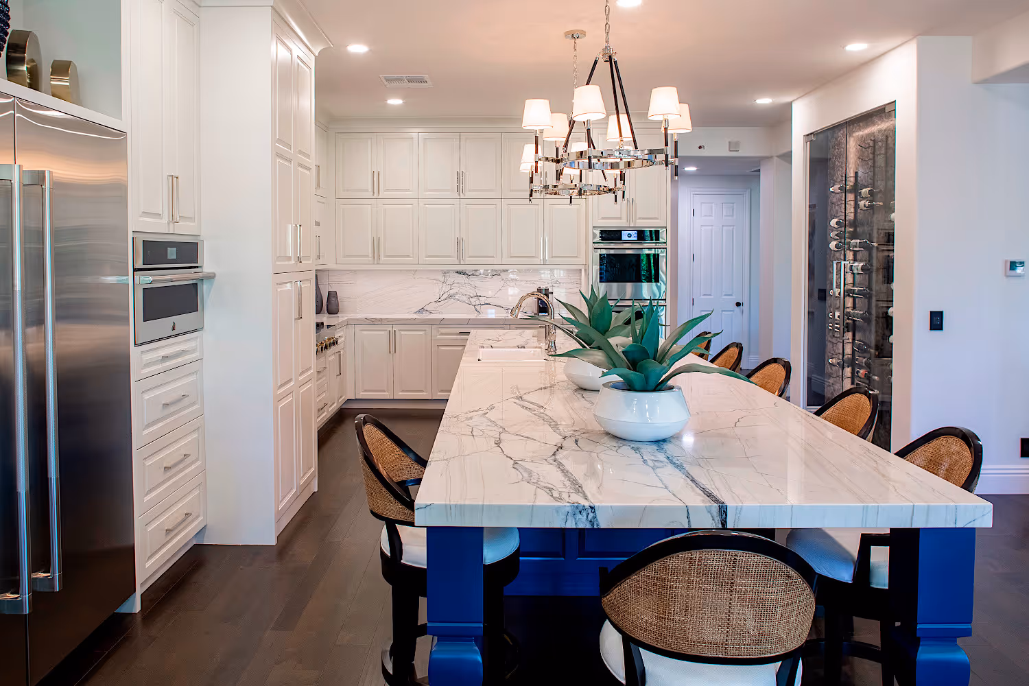 Open floor plan Kitchen with white cabinets and quartzite countertops.