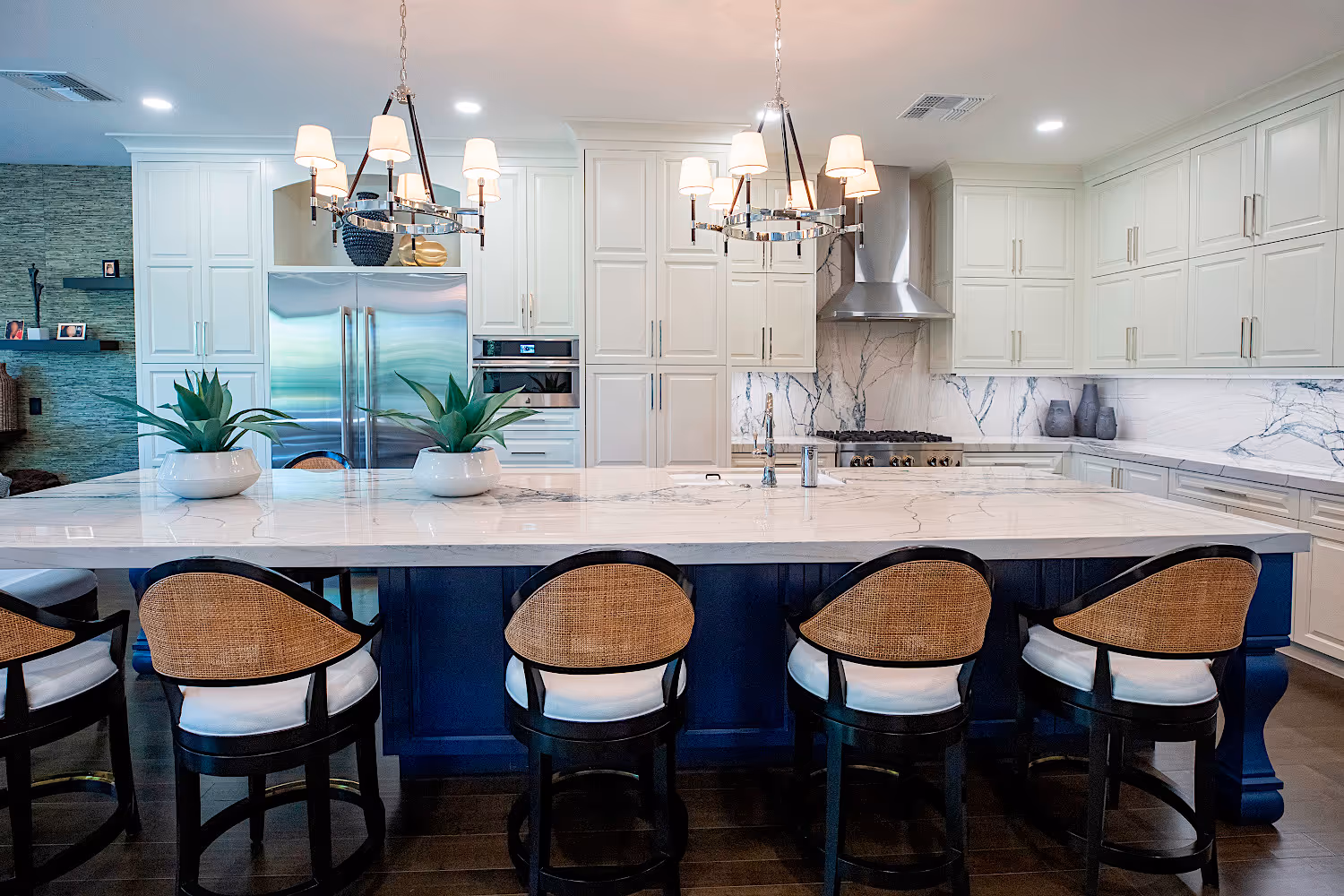 Open floor plan Kitchen with white cabinets and quartzite countertops.
