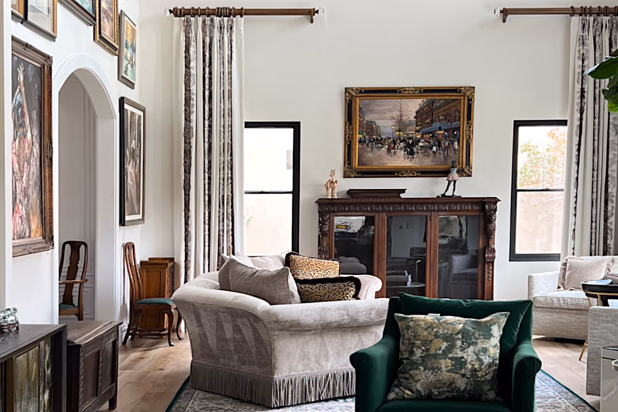 French traditional formal living room with fringed curved sofa.