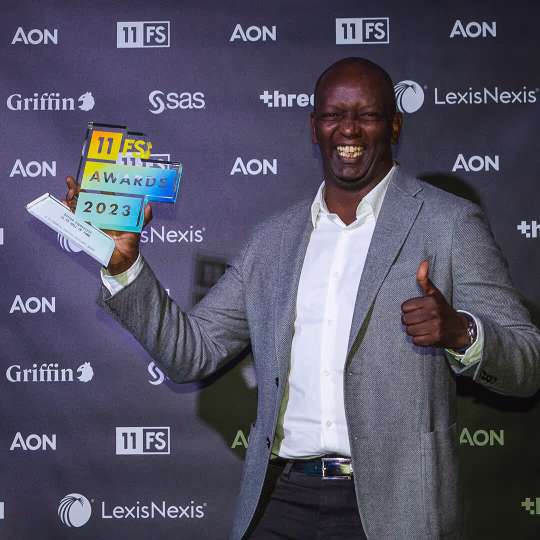 Sitoyo Lopokoiyit holding his 11:FS Hall of Fame award
