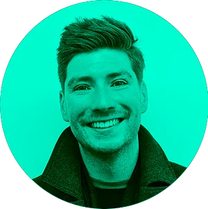 Circular image of a smiling man with short hair, wearing a black jacket on a vibrant green background.