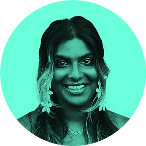 Smiling person with long, dark hair and floral earrings against a turquoise circular background.