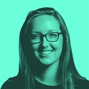 Smiling woman with glasses, featuring long hair, against a bright teal background.