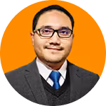 Portrait of a man with short hair and glasses, wearing a gray suit jacket, white shirt, and blue tie, set against an orange circular background.