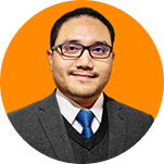 Portrait of a man with short hair and glasses, wearing a gray suit jacket, white shirt, and blue tie, set against an orange circular background.