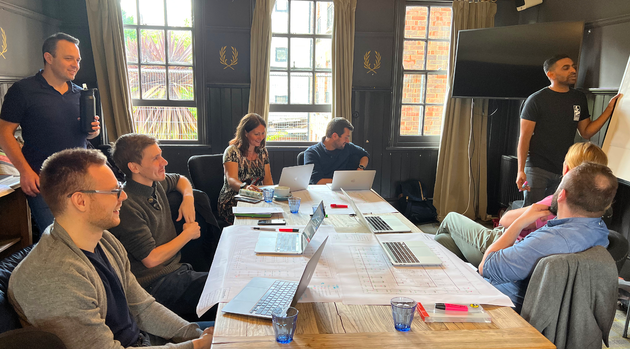 The Countfire team discussing the task whilst sat at a table with laptops.