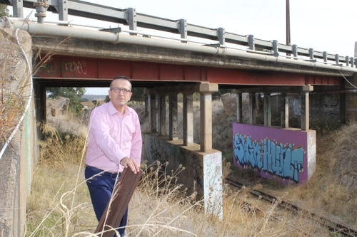 Member of Parliament Tony Piccolo at the Altona Bridge, where the rail line could be cut off again.