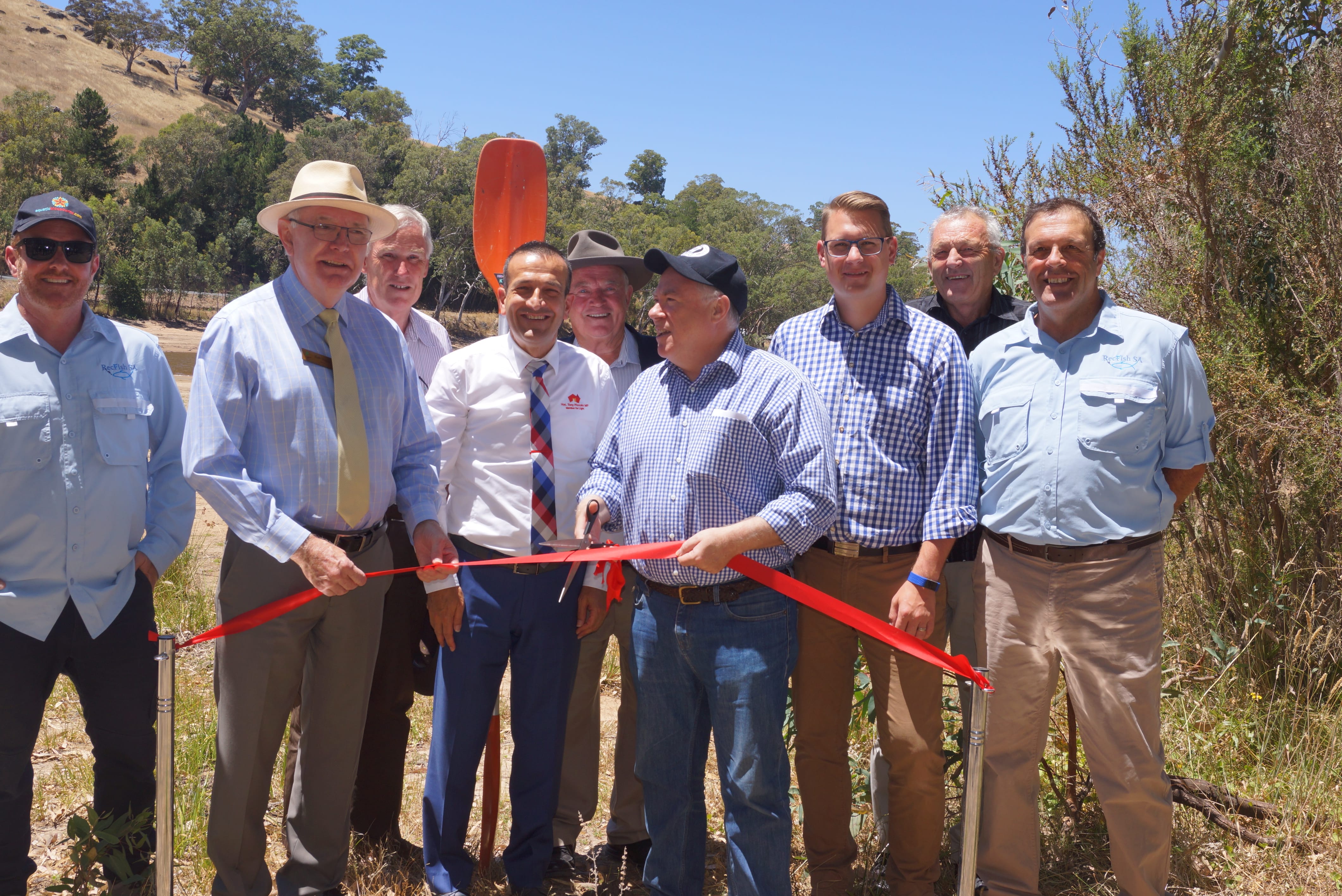 Minister Hunter about to cut the ribbon ( with mayor Sloane) opening the upgraded facilities at the Warren Reservoir with other reps from Rec Fish SA and Barossa Council. 