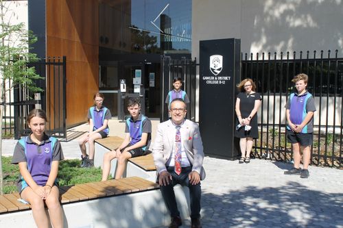 Tony, Principal and students outside the new entrance building.