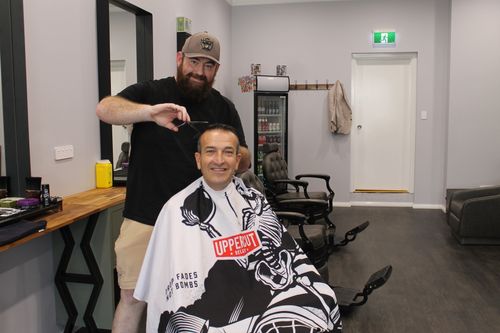 Beast and Beauty Co owner James Somerville talks to local Member of Parliament Tony Piccolo about his new barber shop