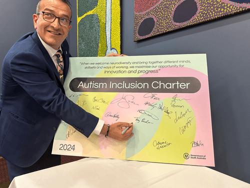 Mr Piccolo signing the Autism Charter in Parliament House recently.
