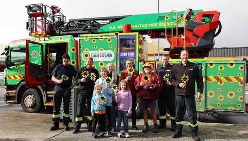 MFS' Damien Gore and Neil Turner, Jesse Modra (front), Nya Modra (middle), Shani Modra (back), Ellie Modra (front), Tony Piccolo MP, Bob Modra, and MFS' James Clements and Ben Whitlock.