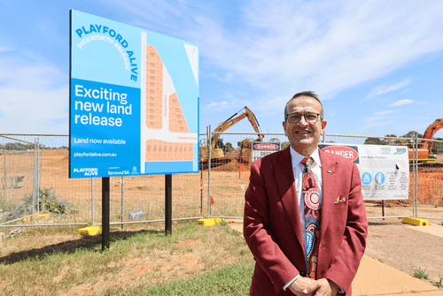 Photo of local MP, Tony Piccolo with civil works underway for the new housing development and extension of Newton Boulevard.