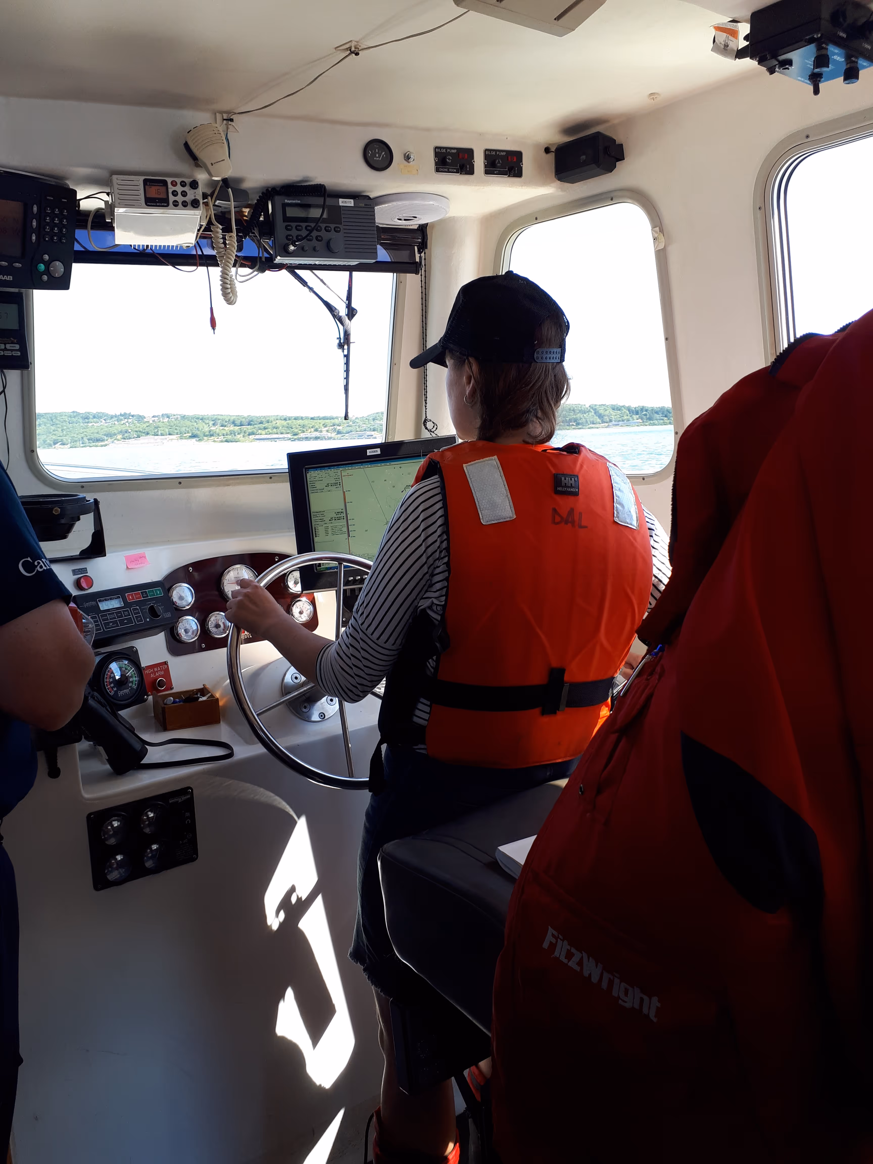 Driving a boat from inside the cabin.