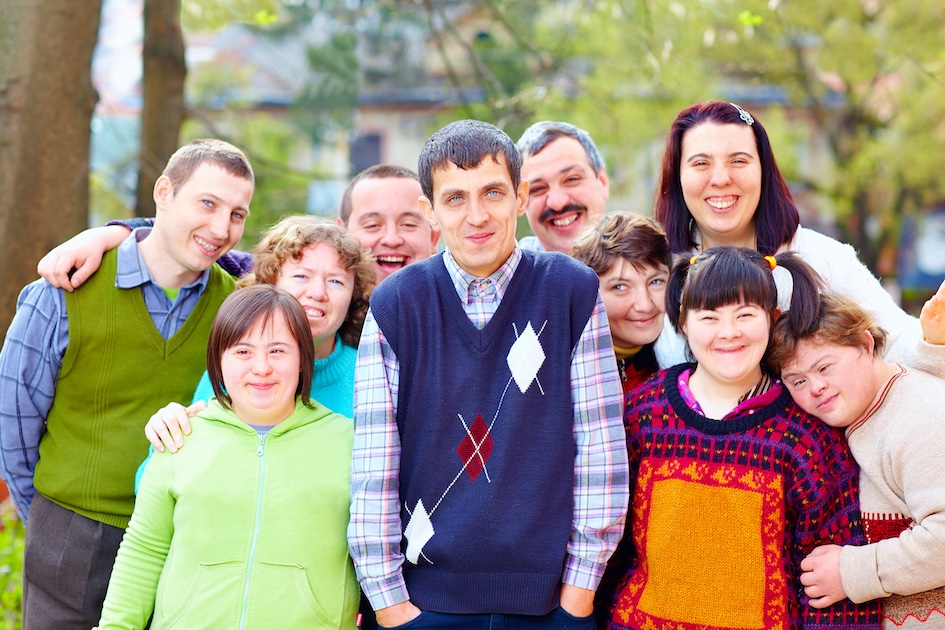 Group of smiling individuals with a variety of special needs