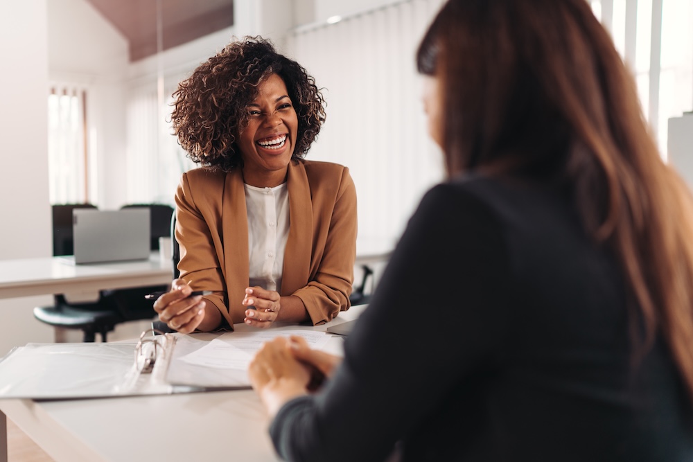 fiduciary at desk talking to a client