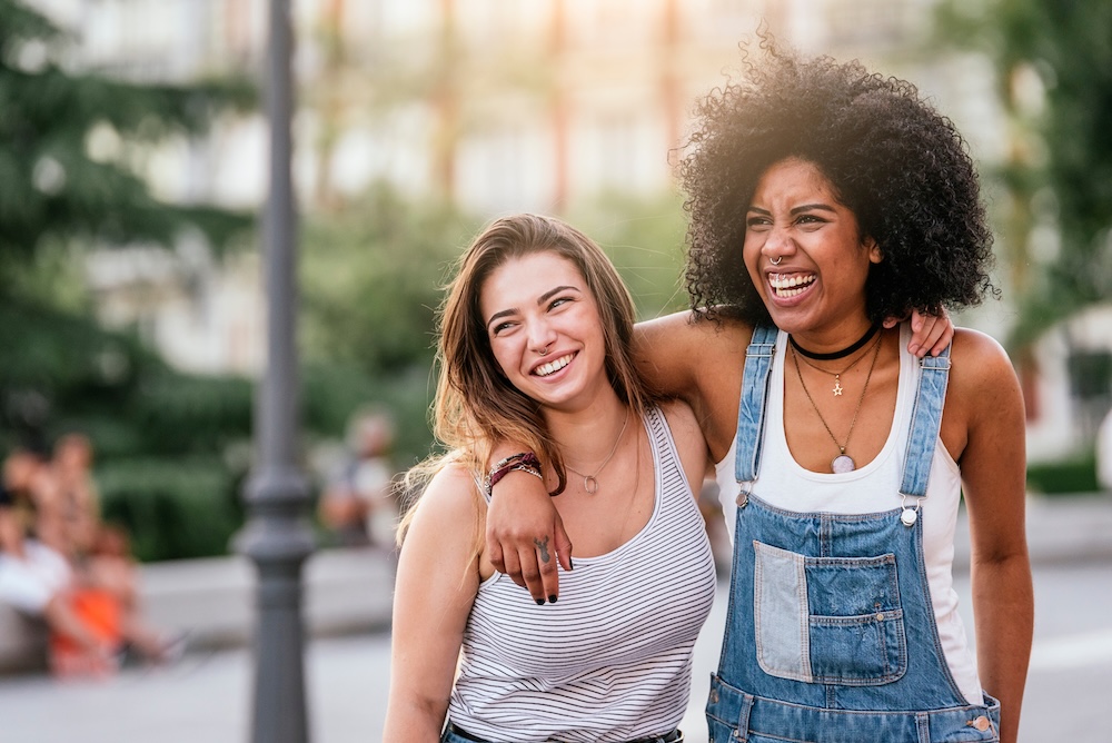 two women smiling outside