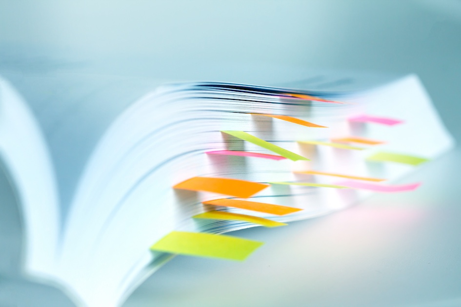 colorful abs organizing an extra thick binder of paperwork - bright and bold colors